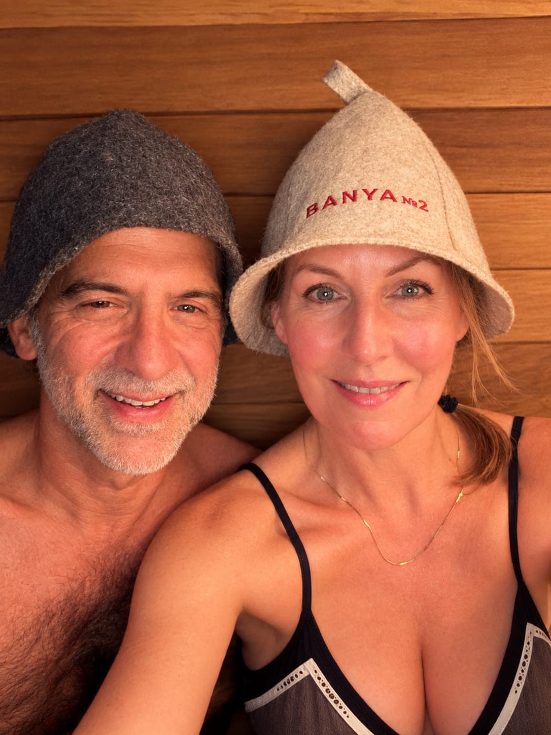 Alan and Jennifer Grandy in their sauna, both wearing felt sauna hats